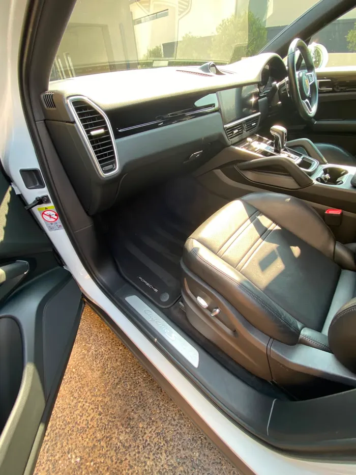 Porsche Cayenne S driver footwell after an interior valet by OTG Mobile Detailing in Johannesburg