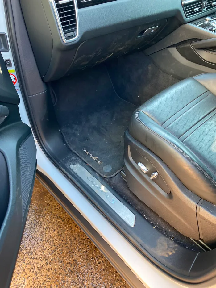 Porsche Cayenne S driver footwell before an interior valet by OTG Mobile Detailing in Johannesburg